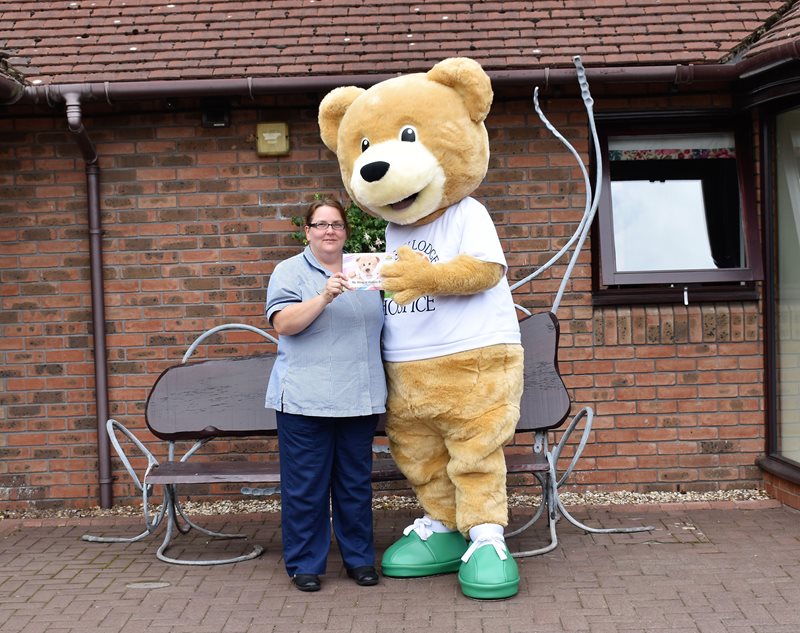 Lindsey Lodge Hospice Staff Nurse Elaine Bradley, who features in the Hospice’s new children’s book, is pictured with Lindsey Bear at the Hospice.