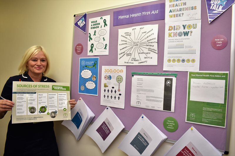 Mental Health First Aider Karen Andrew pictured with the mental health awareness display