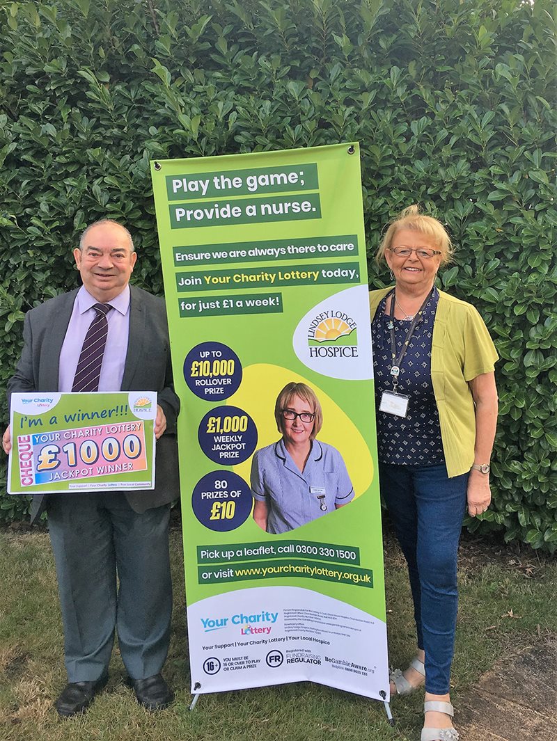 Peter Clark pictured with his lottery win with Peter Dennis and Anne millett